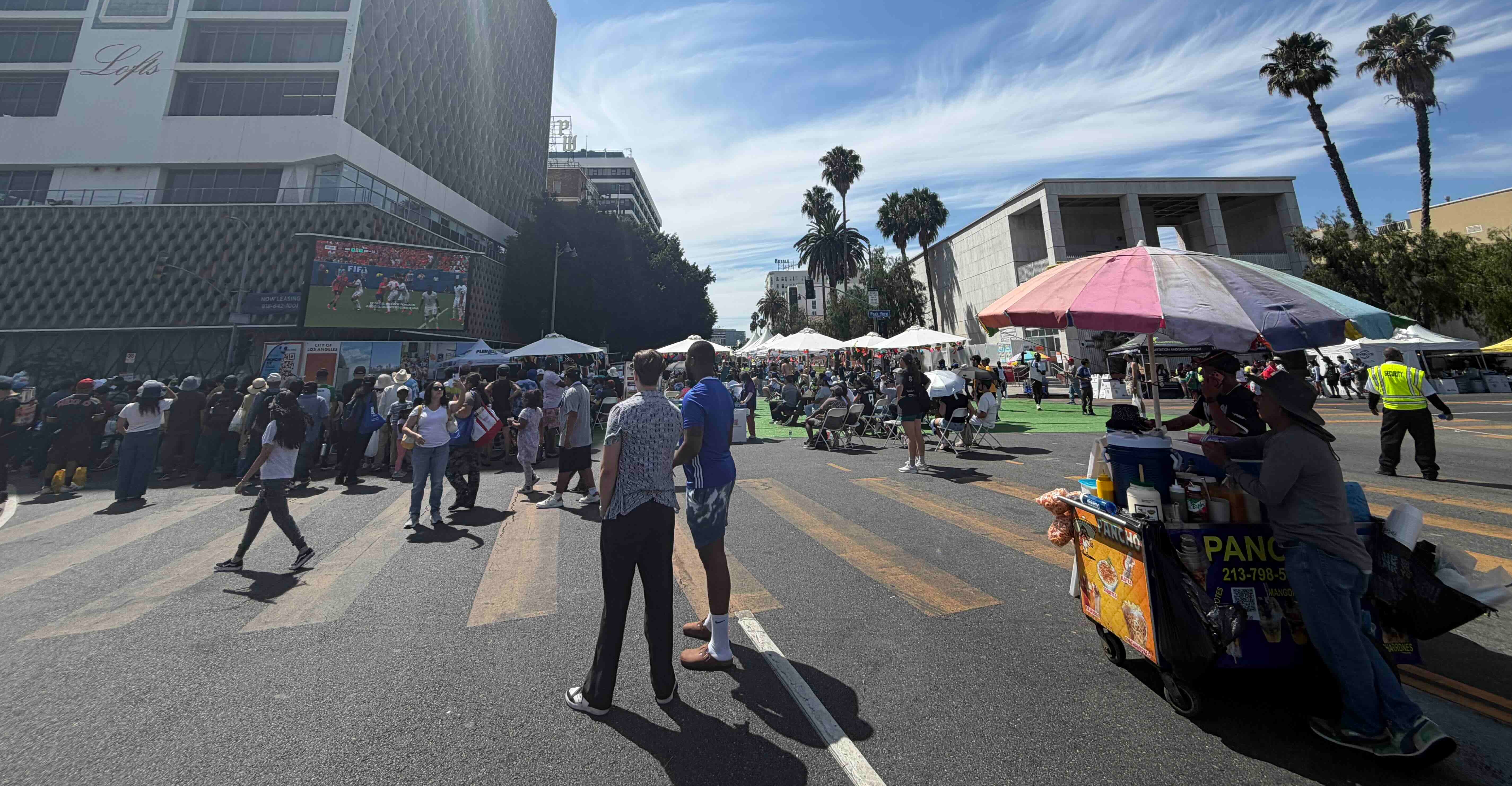 street vendor and people watching world cup on an outdoor plaza
