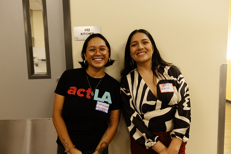 A photo of ACT LA staff members Carmina and Cynthia standing next to each other and smiling.